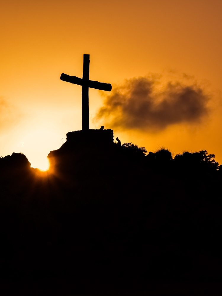 cross with sun in background